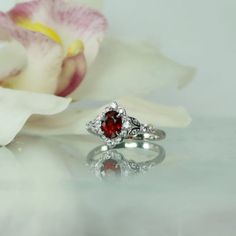 Oval red spinel ring is stunning. Natural spinel gemstone weighs 1.1 carats and has amazing clarity and sparkle. The color of this gemstone is a brilliant red.  Oval red spinel ring has both grace and style. Bonded with rhodium to prevent tarnish. A perfect choice for those with an active lifestyle. Spinel is very durable and handles day to day wear and tear beautifully. Spinel is an 8 on the harness scale comparable in durability to a sapphire. This gem is not treated in any way. Spinel is a st Red Oval Crystal Ring For Wedding, Oval Red Crystal Ring For Wedding, Exquisite Ruby Ring With Gemstone Accents For Anniversary, Exquisite Ruby Ring With Accent Stones For Gift, Exquisite Ruby Rings For Gift, Exquisite Ruby Rings As Gift, Elegant Garnet Crystal Ring With Gemstone, Elegant Garnet Crystal Ring, Elegant Red Sterling Silver Ring