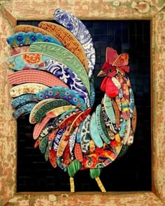 a rooster made out of different colored plates