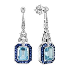 A pair of emerald cut blue topaz stones, precisely matched by eye, totaling 5.90 carats, and set into a pair of exquisite drop ear studs. These exquisite earrings are complimented by 3.78 carats of French cut blue sapphire and round diamonds finished into 14k white gold. Earrings Information Metal: 14K White Gold Width: 12 mm. Length: 39 mm. Weight: 8.50 g. (approx. in total) Backing: Push Back Center Gemstones Type: Blue Topaz Shape: Emerald Cut Size: 9x7 mm. Number: 2 Weight: 5.90 Carat (appro Earring Box, French Cut, Blue Topaz Stone, Art Deco Earrings, Topaz Stone, Gems Jewelry, Art Deco Jewelry, Exquisite Jewelry, Sapphire Diamond