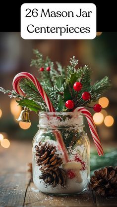 A mason jar centerpiece decorated with Epsom salt, pinecones, holly, bells, and candy canes for a winter wedding. Mason Jars Christmas Centerpieces, Fairy Lights In Mason Jars Centerpieces, Christmas Deco Table Ideas, Christmas Candy Jars Decoration, Winter Decor Table Centerpiece Ideas, Silver Table Decorations Christmas, Diy Candy Cane Centerpiece, Christmas Mason Jar Candle Holders, Christmas Decor With Mason Jars