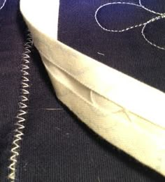 closeup of the stitching on an unbuttoned piece of clothing fabric