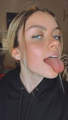 a woman sticking her tongue out to the side