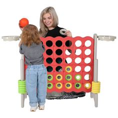 a woman and child playing with a giant connect - a - box board game on an isolated white background