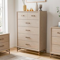 a bedroom scene with focus on the chest of drawers and an art piece in the background