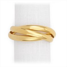 a gold ring on top of a white napkin