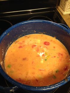 a pot filled with soup sitting on top of a stove