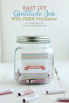 a mason jar filled with toothbrushes on top of a white table next to a sign that says easy diy gratitude jean with free printable tags