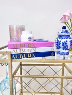 a table topped with books and vases filled with flowers