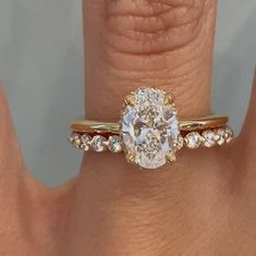 a woman's hand with a ring on it and a diamond in the middle