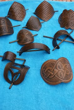 many different types of wooden buttons on a blue cloth