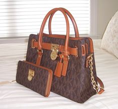 YOU ARE BIDDING ON A Michael Kors Hamilton EW Signature Satchel & Hamilton Large Zip Around Wallet Style No. 30T2GHMS3B & 32T2GHMZ3B Color: MK Sig Logo Brown MSRP $446.00 New with Tags    CONDITION: BRAND NEW WITH ORIGINAL TAGS, NEVER USED GUARANTEED AUTHENTIC!!!!   This set contains a brand new MICHAEL KORS Hamilton EW Signature Satchel  and matching Hamilton Large  Zip Around Wallet, with original tags attached. This is a very eloquent medium-sized PVC satchel Cheap Michael Kors, Mk Logo, Ladies Handbags, Wallet Fashion, Michael Kors Hamilton, Style Accessories, Design Fashion, Michael Kors Bag, Diy Design