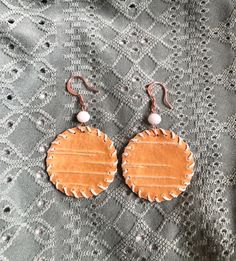 A one-of-a-kind piece of Alaska! These earrings are made with birch bark paper from trees found in remote areas of South-central Alaska. I gathered the material from the natural shedding of the trees and from wood harvested for the stoves that heat my home in the winter.  The 12 different varieties of birch trees that grow in Alaska provide a material that has its own personality, from striking color to distinctive patterns. Each piece would be a unique addition to anyone's jewelry collection! CARE: Each earring is reinforced with a copper backing that allows for both durability and the natural movement of the birch paper. The slight curving that may occur can be reset gently with your fingers or by placing the flat pieces of the earring between a heavy book for a couple of days. Keep thes Birch Bark Earrings, Birch Jewelry, Orange Circle, Natural Movement, Birch Trees, Birch Bark, South Central, Thing 1 Thing 2, Gift Baskets