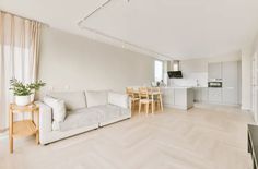 a living room filled with furniture and a flat screen tv on top of a hard wood floor