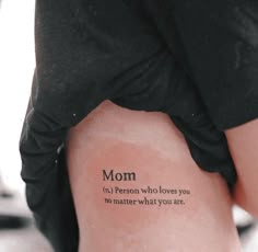 a woman's back with the words mom written on her lower leg and foot