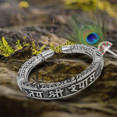 92.5% pure silver handmade excellent unisex bangle bracelet kada, amazing Divine lord Krishna "JAI SHRI SHYAMA" Mantra kada, best customized chitai work unisex personalized gift from India, Metal-925 sterling silver. Item type-Bangle bracelet. Weight-42.420 grams width-1.0 cm size-2-6 to 2-10 or (easily wear by twisting both faces of kada) stamped-925 Finish-oxidized. makes excellent gifting for birthdays, mother's day, wedding anniversaries, valentines day, Christmas day Handmade Silver Bangle For Puja, Sterling Silver Bangle For Ceremonial Festivals, Spiritual Silver Bracelets For Navratri, Silver Openable Bangle For Festivals, Sterling Silver Bangle For Rituals And Festivals, Silver Spiritual Cuff Bracelet For Ceremonies, Spiritual Sterling Silver Bracelet With Intricate Design, Fusion Style Openable Bracelets For Festivals, Silver Bracelet For Puja And Festivals