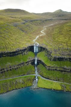 an aerial view of a waterfall in the middle of nowhere