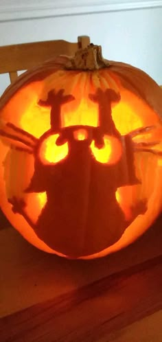 a carved pumpkin with an image of a cat on it