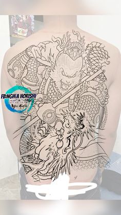 the back of a man's body with tattoos on it and an image of a dragon