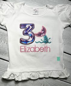 This is a custom embroidery Mermaid Tail  Birthday Theme Shirt! Mermaid  Birthday Shirt|  Sparkle Under the Sea Shirt| Custom Sea Animals  Birthday Shirt| Mermaid Tail  Birthday Shirt| Girls Glitter Shells Top The shirts are personalized with ages 1 to 9. *Want to change the color scheme? No problem! Just message me or leave your requests at checkout. Please note that all my embroidered items have a soft backing cover to protect your little one skin from any irritation. The onesies and shirts I use are boutique quality!! They are 100% cotton and run true to size. The shirts have puffy sleeves and are girls fitted style. I used glitter materials, the birthday shirt can be customized in terms of colors ,so you can always message me and we can discuss! I am NOT RESPONSIBLE for costumer error Fun Fitted T-shirt For Birthday, Customizable Fitted T-shirt For Birthdays, Blue Fitted Top For Birthday, Fitted Blue Top For Birthday, Long Sleeve Summer Shirt For Birthday, Pink Embroidered Top For Birthday Party, Embroidered Pink Tops For Birthday, Pink Embroidered Top For Birthday, Customizable Fitted T-shirt For First Birthday