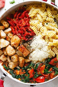 a pan filled with pasta, meat and vegetables