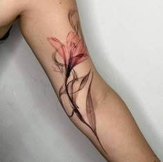 a woman's arm with a flower tattoo on the left side of her body