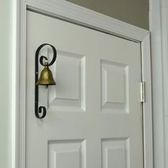 a white door with a bell on it