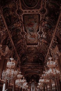 an ornately decorated hall with chandeliers and paintings on the ceiling, in black and white