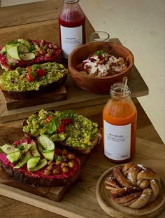 three wooden trays filled with different types of food and condiments next to each other