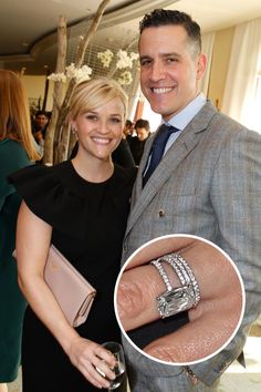 a man and woman standing next to each other with their engagement rings on their fingers