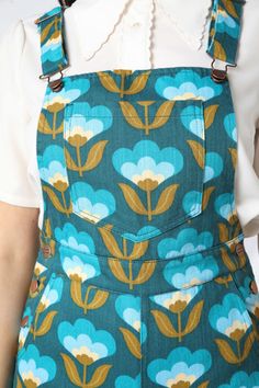 Wallpaper printed overall - revive your retro vibe in this super funky 70’s inspired design - bib and brace style - adjustable straps - lots of handy pockets - high waisted rise - straight full length leg - made from cotton drill fabric - available in teal Product Code: PGFV061127