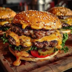 two cheeseburgers sitting on top of a wooden cutting board next to each other