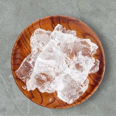 some ice cubes are on a wooden plate