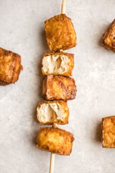 some food is sitting on a stick with toothpicks in it and ready to be eaten