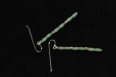 The earrings are made of 6 barrel-shaped pieces of beautiful green turquoise and 2 cylidrical handmade silver pieces, stacked on a long silver stick and attached to a sterling silver hook. Turquoise is one of the oldest protection amulets, and was also known as a symbol of wealth and nobility in many ancient cultures. They can be combined with a matching turquoise and silver beads necklace and bracelet. All silver parts are hand crafted in 98% Silver by Thai Karen hill-tribe artisans. The Karen Silver Minimalist Beaded Earrings, Turquoise Beaded Earrings With Silver Beads As Gift, Turquoise Sterling Silver Earrings With Silver Beads, Turquoise Earrings With Silver Beads, Turquoise Drop Earrings With Silver Beads, Turquoise Earrings With Silver Round Beads, Turquoise Silver Beaded Dangle Earrings, Turquoise Dangle Earrings With Silver Beads, Protection Amulet