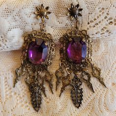 So Beautiful! Vintage Dangle Earrings Large purple facetted glass stone For Pierced ears, post Prong set See photos for size EXCELLENT CONDITION no flaws Vintage Purple Teardrop Earrings, Purple Jeweled Dangle Earrings, Unique Purple Jeweled Dangle Jewelry, Purple Jeweled Drop Earrings, Purple Jeweled Earrings As Gift, Purple Jeweled Earrings For Gift, Vintage Amethyst Purple Earrings, Vintage Purple Drop Earrings, Purple Drop Crystal Earrings