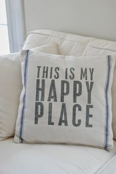 a pillow that says, this is my happy place on the back of a couch