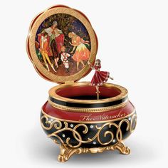 an ornately decorated music box with a painting on it's lid and stand