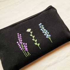 Handpainted black school pencil case with flowers. Ideal for storing anything: pencils, markers, makeup...  It's perfect for school, to go on a trip as a toiletry bag and it's an ideal complement to our bags where we can store the smallest things and not lose them.  The measurements are: 21cm x 13cm (8,27" x 5,12") I tell you how I painted it:  First, I wash the pencil case. This is how I get the final size of the pouch (you will not be surprised when washing it because it already has its final Black Zipper Pencil Case For Personal Use, Black School Pouch With Pen Holders, Black Pouch With Pen Holders For School, Black Travel Cosmetic Bag With Pen Holders, Back To School Black Pencil Case For Daily Use, Black Pouch Cosmetic Bag For School, Black Pencil Case For Back To School, Black Pencil Case For Back To School Gift, Black Pencil Case With Pen Holders As Gift