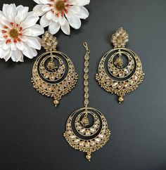 This Maangtikka and earring/jhumka set with beads in round shape comes in 2 beautiful colors, gray and Gold! The set is lightweight and has a beautiful finish with gold polki work and beads. perfect for light occasions or bridal wear, this set is handmade has a beautiful shine and statement shape. This lightweight and elegant set is perfect for any bridesmaid, bride, sangeet or any occasion or event as a gift for any occasion as any one who loves jewelry will love this statement piece. It has be Luxury Gold Plated Bridal Earrings With Meenakari, Eid Jewelry Sets With Chandbali Latkans, Eid Jewelry Sets With Latkans And Chandbali Shape, Hand Set Chandbali Tikka For Festivals, Gold Chandbali Jewelry Sets, Gold Round Bollywood Tikka, Gold Bollywood Style Round Tikka, Gold Bridal Sets With Chandbali Latkans, Hand Set Chandbali Tikka For Diwali