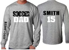 Soccer Dad Shirt | Soccer Long sleeve (one sleeve/one word only) Shirt | Customize your team & colors PLEASE READ BEFORE ORDERING WE CANNOT RUSH ORDERS OR CREATE NEW DESIGNS DURING PEAK SEASON AUG - MAY. IF YOU NEED TO CANCEL PLEASE DO SO WITHIN 24HRS Please read full description before ordering we cannot be responsible for mistakes made by not reading the full description. ORDERING INSTRUCTIONS: 1. Select your Garment Size/Color Each size must be selected separately. Please do NOT leave a l Long Sleeve T-shirt With Logo For Sports Events, Varsity Long Sleeve T-shirt With Team Name, Long Sleeve Sports Fan T-shirt, Pre-shrunk Long Sleeve T-shirt For Sports Events, Team-colored Long Sleeve T-shirt For Game Day, Sports Fan Long Sleeve T-shirt For Baseball Season, Long Sleeve Sports Fan T-shirt For Baseball Season, Long Sleeve T-shirt In Team Colors For Game Day, Team Spirit Long Sleeve T-shirt For Sports Events