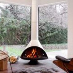 a living room filled with furniture and a fire place next to a large glass window