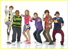 the cast of gleed is posing in front of a white background with their hands up