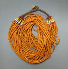 This ethnic necklace with 20 strands orange glass beads originates from the Naga.  The hanging length of the necklace is 28 cm. The average diameter of the beads is 0.3 cm.  Its weight is 203 gram. (s30) SHIPPING SHIPMENT is FREE. All items are shipped every week on monday morning after receipt of payment. We send priority airmails. Please consider overseas shipments take usually 5 - 8 days. Insured packets (over 50 cm length / over 1500 gram) I send by standard way. PAYMENT Paypal is preferred. Orange Multi-strand Beaded Necklaces, Orange Multi-strand Beaded Necklace, Orange Multi-strand Polished Beaded Necklaces, Orange Multi-strand Beaded Necklace With Polished Beads, Orange Multi-strand Polished Beaded Necklace, Orange Wooden Beads For Festival, Orange Wooden Beads For Festivals, Orange Polished Bead Necklaces For Festivals, Bohemian Orange Beads For Jewelry Making