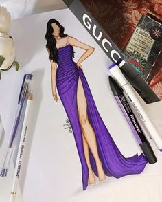 a drawing of a woman in a purple dress next to some markers and pens on a sheet of paper