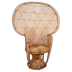 a wicker chair with an umbrella shaped backrest and foot rest on it's side