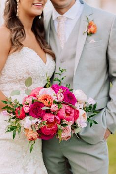 a bride and groom pose for a wedding photo