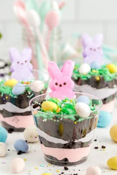 two dessert cups filled with chocolate cake and decorated easter bunnies on top of them