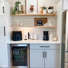 a kitchen with white cabinets and open shelves