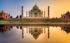 the tajwa mosque in india is reflected in the water