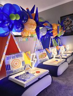 a room filled with lots of blue and orange balloons